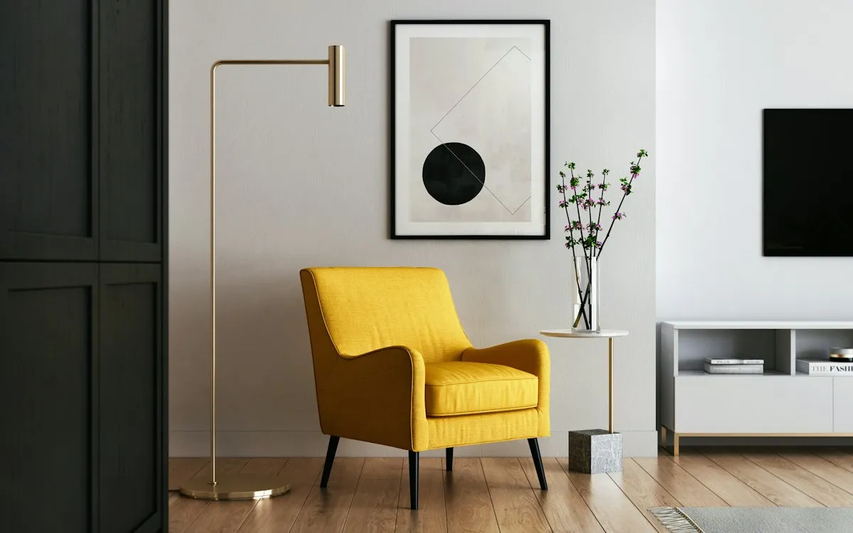 Bright minimalist living room with a yellow armchair and clear, uncluttered surfaces