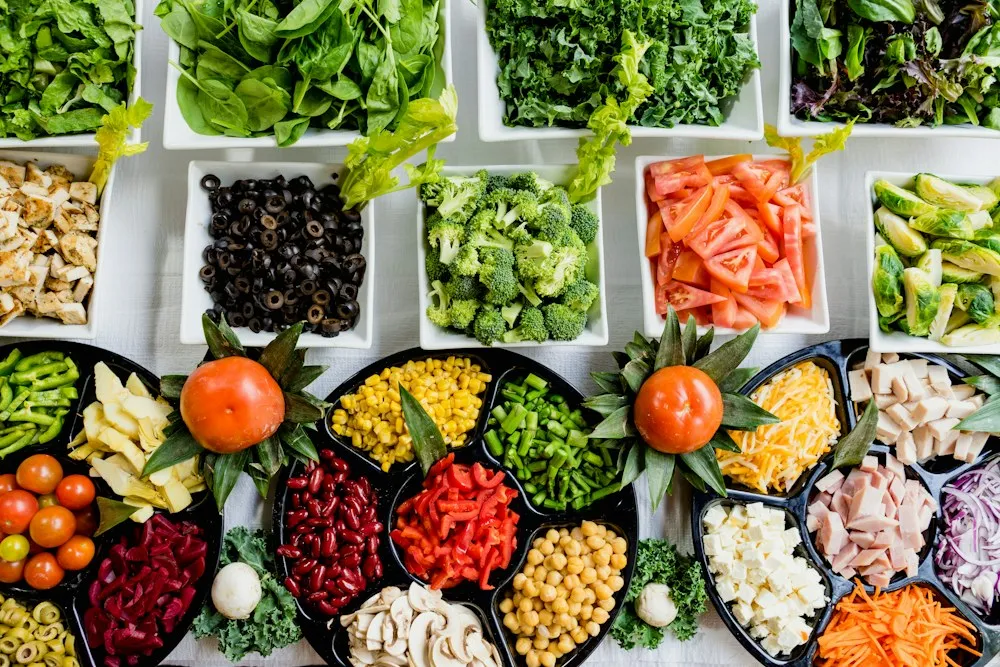 Colorful bowls of fresh vegetables, whole grains and legumes laid out for weekly meal prep