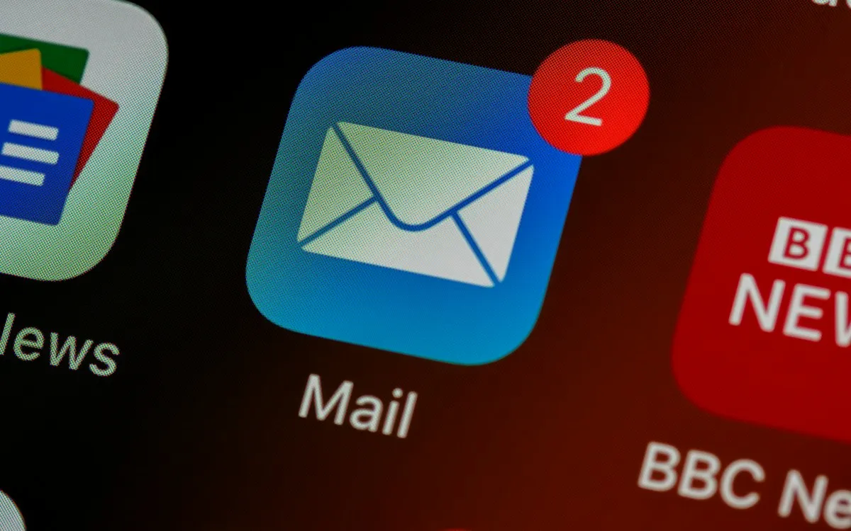 Close-up of a phone screen showing the Mail app icon with a notification badge