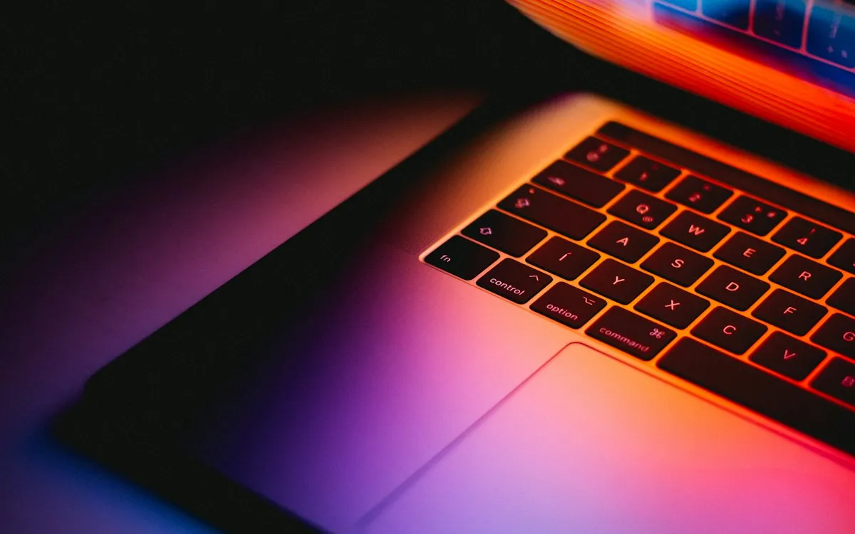 Laptop keyboard glowing with purple and orange backlighting